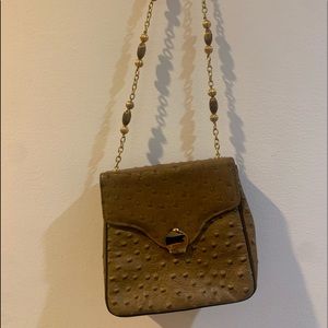 Beautiful Triangle New York handbag with unique gold chain